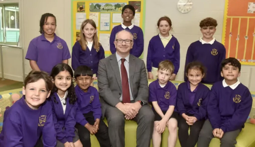 Headteacher Richard Cunningham with children at St Peter's Catholic Primary School